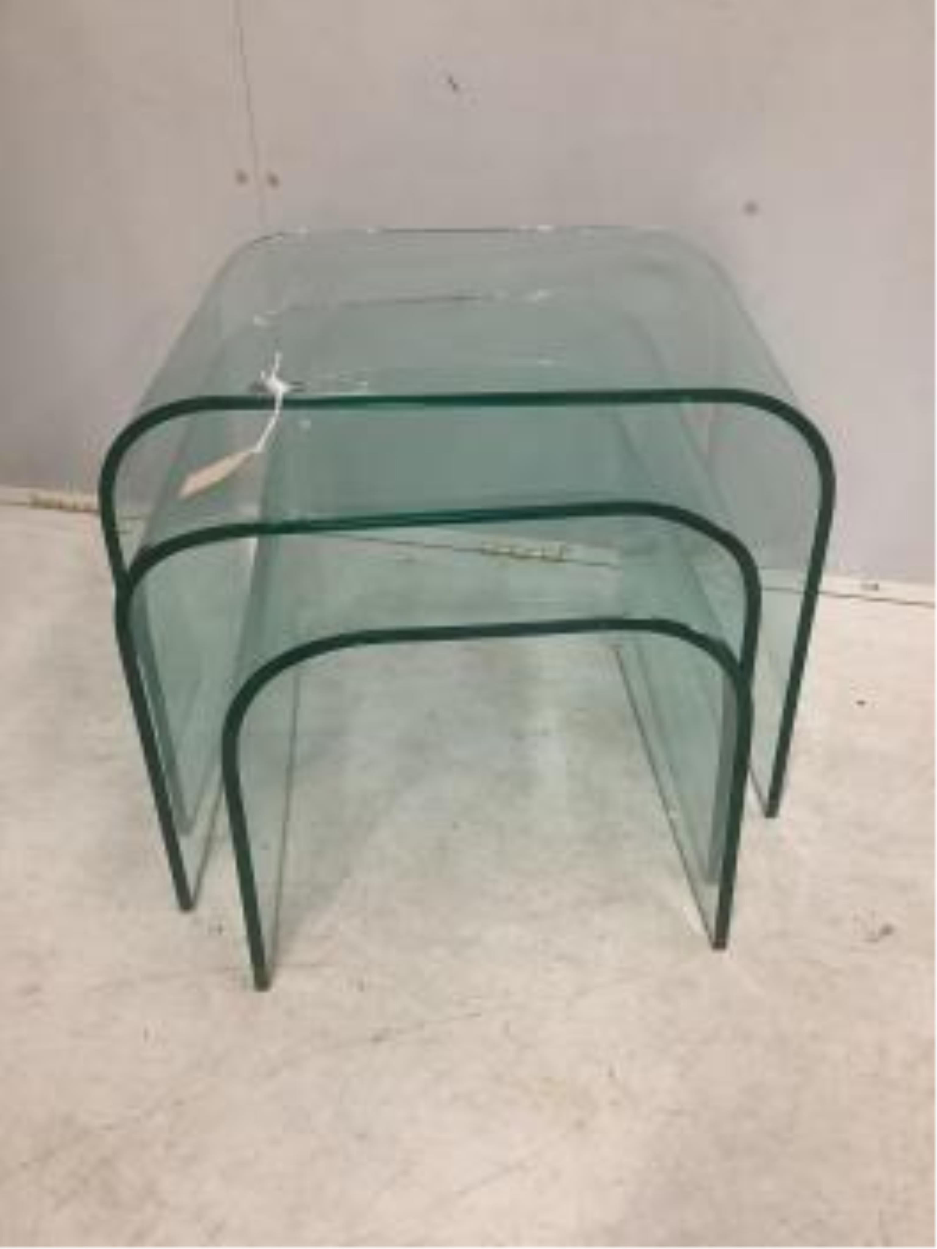 A nest of three Contemporary curved glass tables, width 59cm, depth 44cm, height 45cm. Condition - good